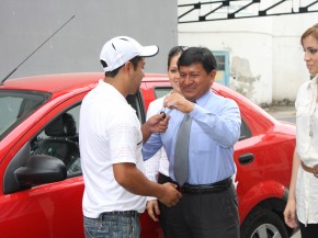 Gustavo Cristobal, Administrative Assistant Industrial Molinera, gives car keys to Christian Yugcha Castro.